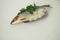 Fish. It`s a whole herring. Undivided herring with onions and parsley. White background.