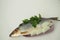 Fish. It`s a whole herring. Undivided herring with onions and parsley. White background.