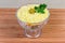 Fish salad mimosa with cheese, eggs, vegetables in glass bowl