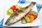 Fish, sea bass grilled with lemon and grilled vegetables