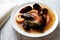 Fish seafood soup bouillabaisse. Mussels, shrimp, lobster in tomato sauce. White wooden background