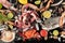 Fish and seafood variety, a flatlay overhead shot on a dark background. Fresh sea bream. shrimps, crab, sardines, squid