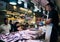 Fish seller in La Boqueria Market in Barcelona, Spain