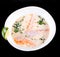 Fish soup with salmon and shrimps, dill, potatoes, lemon and vegetables in bowl, isolated on black background, healthy food.