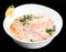 Fish soup with salmon and shrimps, dill, potatoes, lemon and vegetables in bowl, isolated on black background, healthy food.