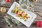 Fish starter food on white plate with christmas decoration. product photography and modern gastronomy