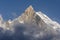 Fish Tail Peak Machapuchare surrounded by rising clouds, Himalayas