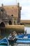 Fisher boats and bastion Borj El Barmil in port of Essouira