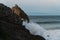 Fisher man working on a huge wavy cliff