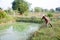 Fisher Old man 60 year old using fishing net catch catfish