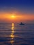 Fisherboat in horizon on sunset sunrise at sea