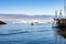 Fisherboats and cruise liner in front of icebergs light blue Arctic Ocean, Greenland