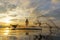 Fisherman action when fishing net on lake in the sunshine morning and silhouette fisherman on the boat,