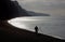 Fisherman angling on beach