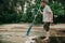 Fisherman with  beard holds  paddle by  river