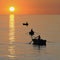 Fisherman on beautiful calm bay at sunrise