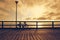 Fisherman bicycle with fishing rods on wooden bridge. Toned.