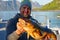 Fisherman with big cod fish. Norwegian fisherman has caught large Cod in Norwegian Fjord islands