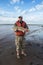 Fisherman with big golden fish Red drum Sciaenops ocellatus in his hands. Autumn fishing. Gulf of Mexico, Texas, US