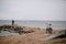 Fisherman with bike on the shore of the Gulf of Finland in cloudy weather