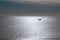 Fisherman boat backlit as silhouette