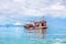 Fisherman boat on blue sea, sky, clouds landscape background close up, beautiful seascape with red wooden fishing vessel, Thailand