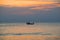 Fisherman on a boat in the Gulf of Siam at sunset background. Thailand