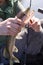 Fisherman in a boat holds a pike fish in his hands close-up. Catching a predatory fish with a spinning rod