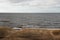 Fisherman boat that lay at the beach front. Baltic beach and its landscape in a cloudy day.