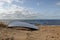 Fisherman boat that lay at the beach front. Baltic beach and its landscape in a sunny day.