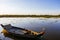 The fisherman boat at lotus farm lake in Cambodia at sunset