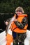 Fisherman on boat in orange vest with his catch.