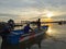 Fisherman on boat during sunset at Kampung Gayang