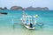 Fisherman boat with view of hills and turquoise ocean in Wedi Ireng beach, Banyuwangi