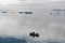 Fisherman boats between icebergs in Arcitic Ocean, Greenland