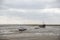 Fisherman boats stuck on the beach in low tide period.