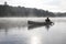 Fisherman Canoeing on a Misty Lake