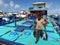 A fisherman carrying fish from a boat to the city market