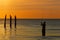 Fisherman casting his line in the Gulf of Mexico at sunset - For