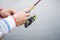 A fisherman catches a fish. Hands of a fisherman with a spinning rod in hand closeup. Spin fishing reel