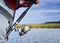 A fisherman catches a fish. Spinning reel closeup. Shallow depth of field on the spool of fishing line