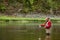 Fisherman catches fish using a fly rod