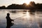 Fisherman catches of salmon at sunset