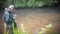 A fisherman catches spinning in the waders. Trout fishing