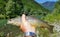 Fisherman catching brown trout in river