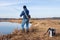 Fisherman catching fish in river at springtime. Man with spinning on fishing