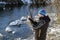 Fisherman checking bait. Open water fishing in winter. Spinning fishing in winter