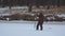 Fisherman drilling hole in the ice on winter fishing