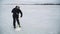 Fisherman drills a hole in a frozen river