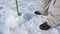 Fisherman drills hole in ice close up view, sport fishing in winter.